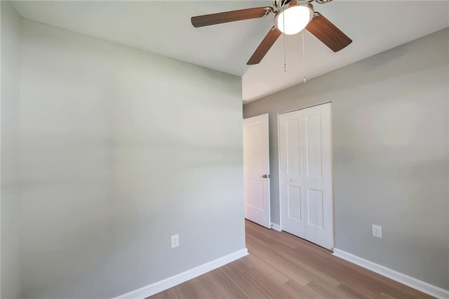 empty room featuring ceiling fan and light wood-type flooring