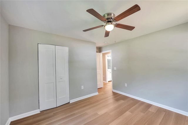 unfurnished bedroom featuring light wood-type flooring, a closet, and ceiling fan