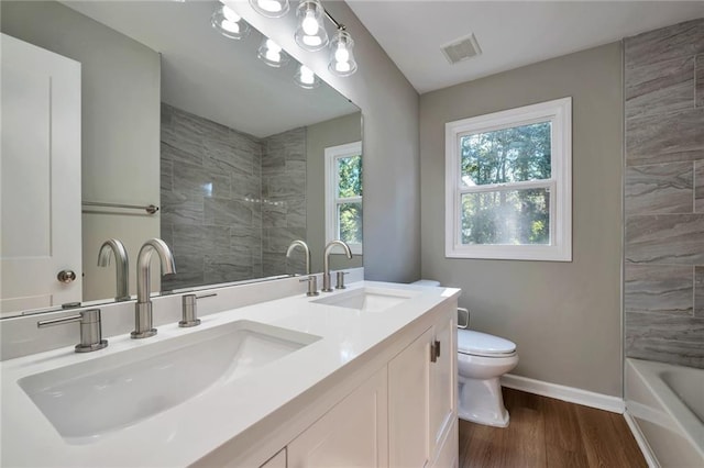 bathroom featuring hardwood / wood-style floors, vanity, and toilet