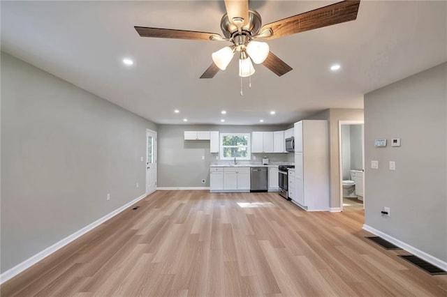 kitchen with white cabinets, ceiling fan, light hardwood / wood-style floors, and stainless steel appliances