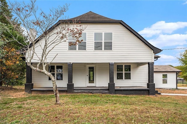 view of front of property featuring covered porch and a front yard