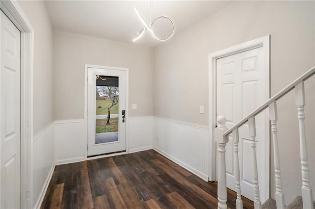 entryway featuring dark hardwood / wood-style floors and an inviting chandelier