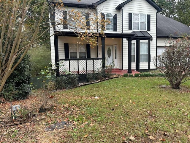 view of front of home featuring a front lawn and covered porch