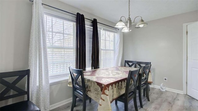 dining room featuring a chandelier and light hardwood / wood-style flooring