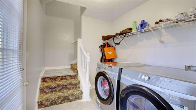 laundry room with light tile patterned flooring, a textured ceiling, and independent washer and dryer