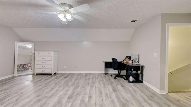 office with a textured ceiling, light wood-type flooring, vaulted ceiling, and ceiling fan