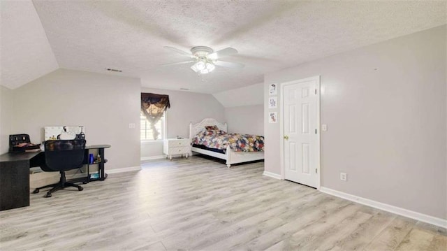 bedroom featuring a textured ceiling, ceiling fan, light hardwood / wood-style floors, and vaulted ceiling