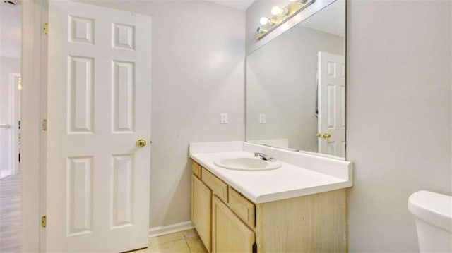 bathroom featuring tile patterned floors, vanity, and toilet