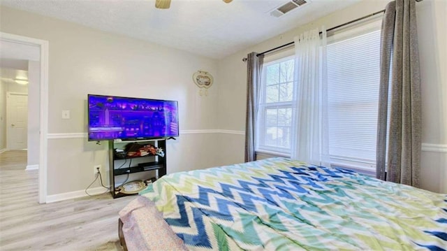 bedroom featuring light wood-type flooring and ceiling fan