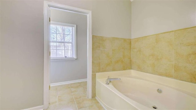 bathroom with tile patterned flooring and a bathtub