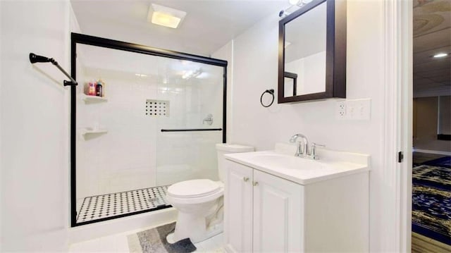 bathroom with vanity, toilet, and a shower with shower door