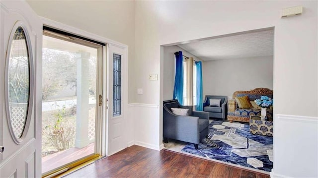 entrance foyer featuring hardwood / wood-style flooring, a healthy amount of sunlight, and a textured ceiling