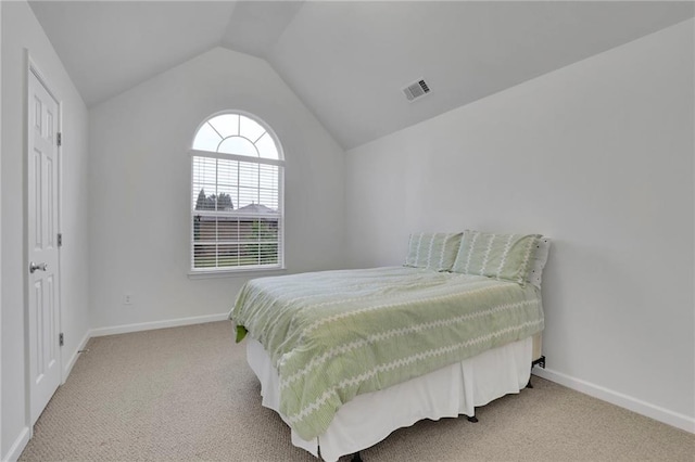 bedroom featuring baseboards, carpet flooring, lofted ceiling, and visible vents