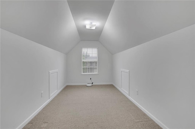 bonus room featuring baseboards, carpet, and lofted ceiling