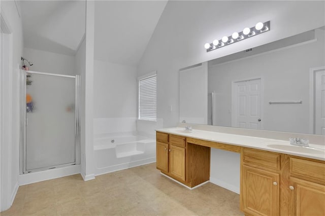 bathroom featuring a sink, lofted ceiling, a bath, and a shower stall
