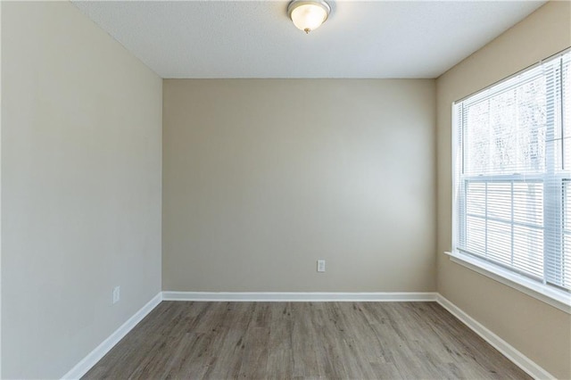 unfurnished room featuring hardwood / wood-style flooring