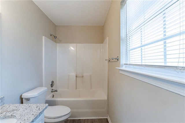 full bathroom with hardwood / wood-style flooring, vanity, bathtub / shower combination, and toilet