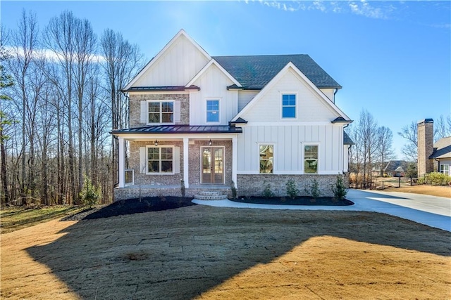 modern inspired farmhouse with covered porch and a front yard