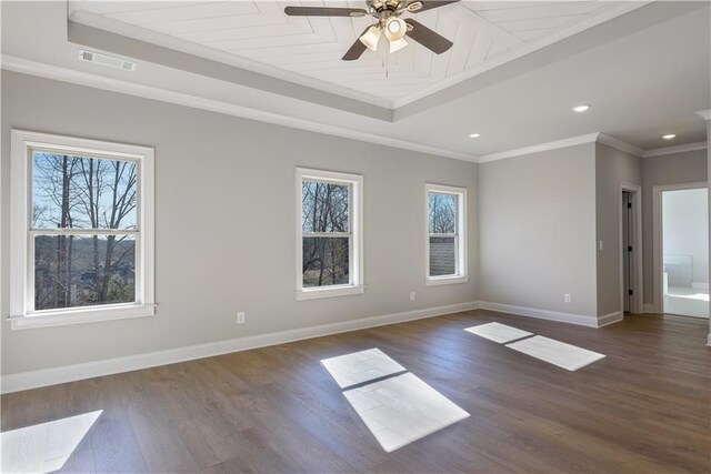 empty room with dark hardwood / wood-style flooring, ceiling fan, ornamental molding, and a healthy amount of sunlight