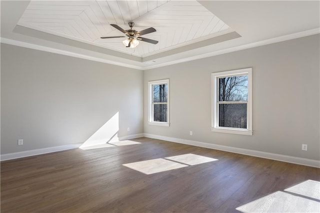 spare room featuring crown molding, ceiling fan, dark hardwood / wood-style floors, wooden ceiling, and a raised ceiling