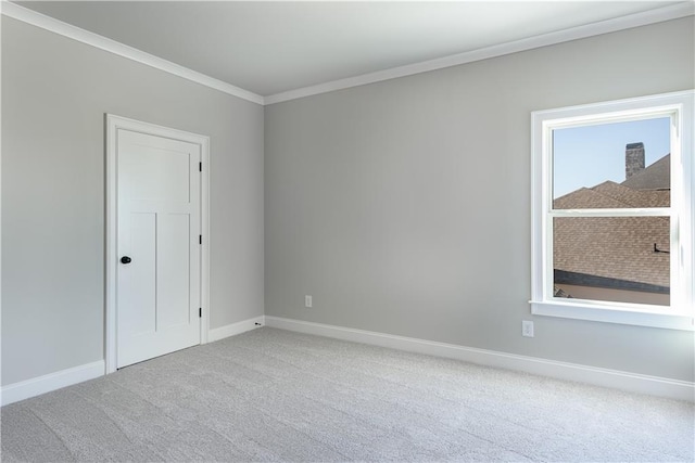 carpeted spare room featuring crown molding