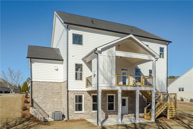 rear view of property with cooling unit and a patio