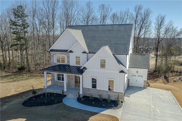 modern inspired farmhouse with a garage and a porch