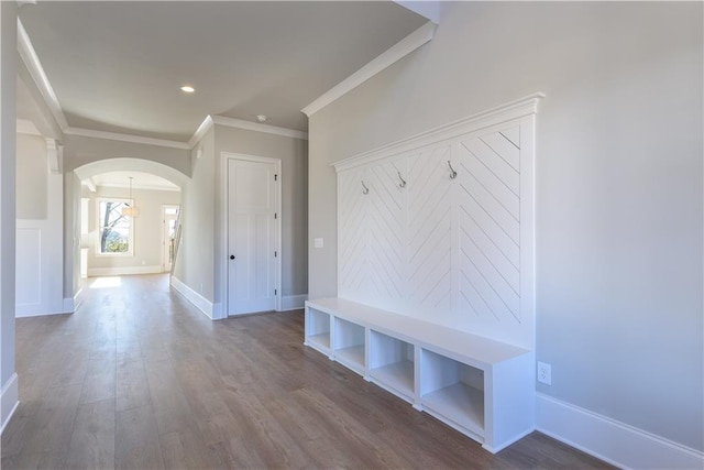 mudroom with wood-type flooring and ornamental molding