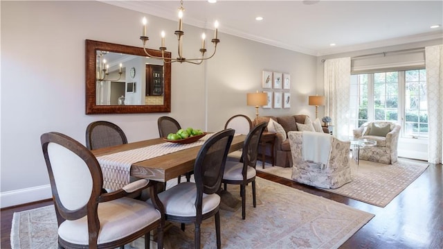 dining room featuring wood finished floors, recessed lighting, crown molding, baseboards, and a chandelier