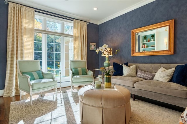 living room featuring recessed lighting, wood finished floors, ornamental molding, and wallpapered walls