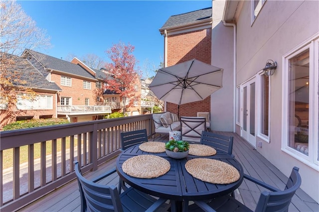 wooden deck with outdoor dining space and a residential view