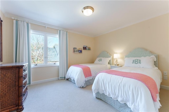 carpeted bedroom with crown molding and baseboards