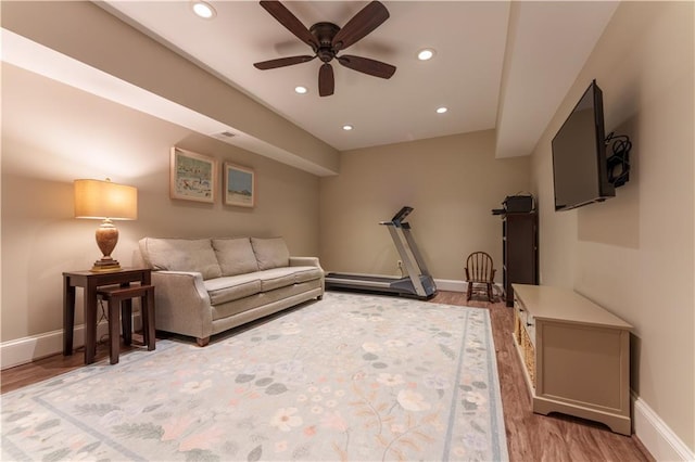 living room featuring recessed lighting, light wood-type flooring, and baseboards