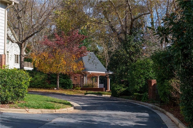 obstructed view of property with aphalt driveway