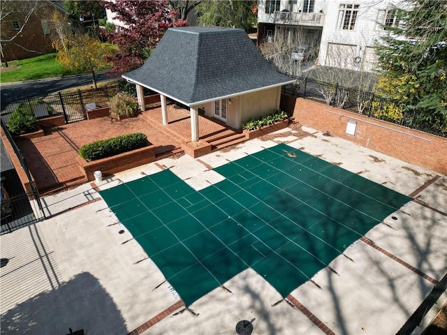 view of swimming pool with a patio and fence