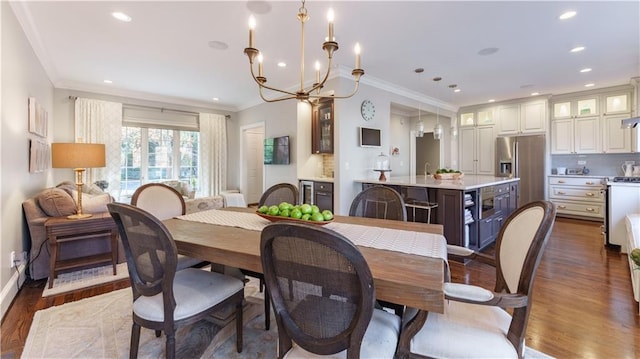 dining space with crown molding, recessed lighting, and dark wood-style flooring