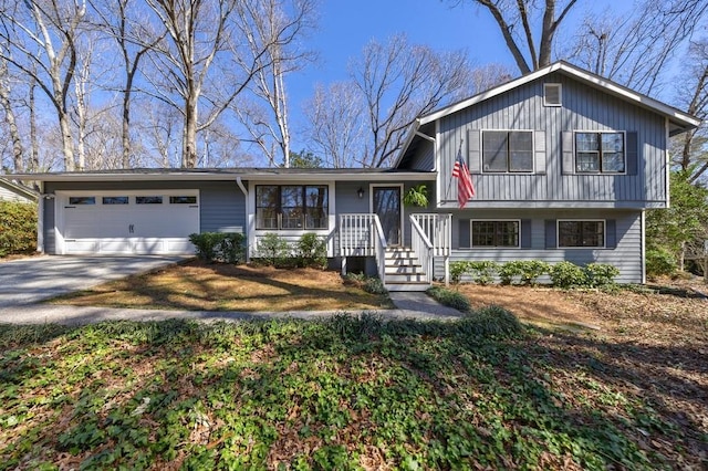 tri-level home featuring a garage and driveway