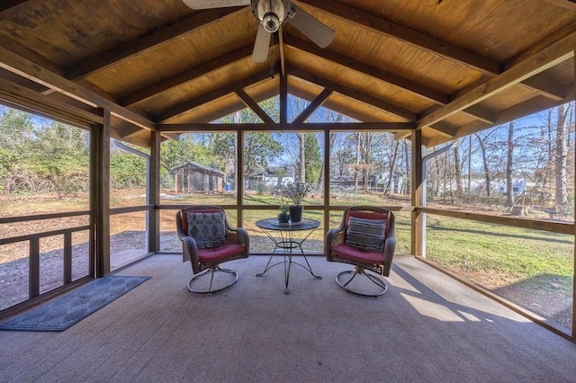 unfurnished sunroom with lofted ceiling with beams, wooden ceiling, and ceiling fan