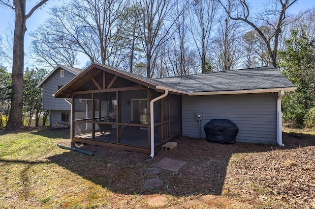 view of front facade featuring a sunroom and a front yard