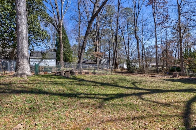 view of yard featuring a vegetable garden and fence