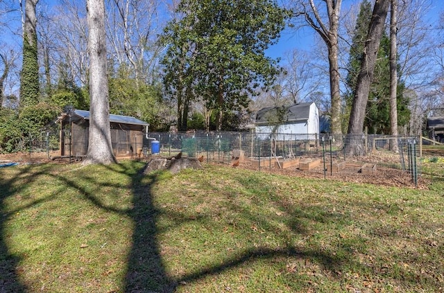 view of yard featuring an outbuilding and fence