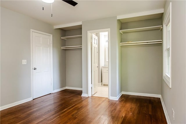 4339 Sasanqua Ct, Tucker, GA 30084 - unfurnished bedroom featuring dark wood-style floors, baseboards, ensuite bath, and a ceiling fan