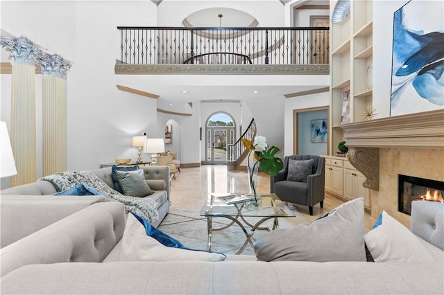 8370 Royal Melbourne Way, Duluth, GA 30097 - living room with a premium fireplace, a high ceiling, and arched walkways