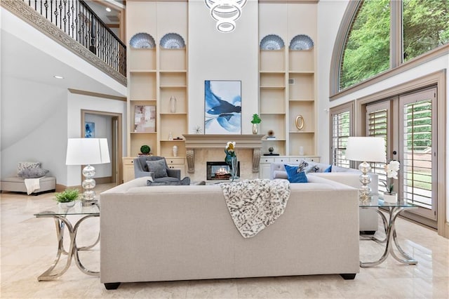 8370 Royal Melbourne Way, Duluth, GA 30097 - living area featuring a towering ceiling, built in features, and a high end fireplace