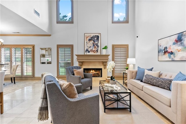 8370 Royal Melbourne Way, Duluth, GA 30097 - tiled living room featuring a towering ceiling, a lit fireplace, and a chandelier