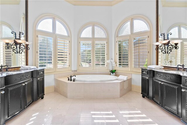 8370 Royal Melbourne Way, Duluth, GA 30097 - bathroom featuring tile patterned flooring, two vanities, a garden tub, and crown molding
