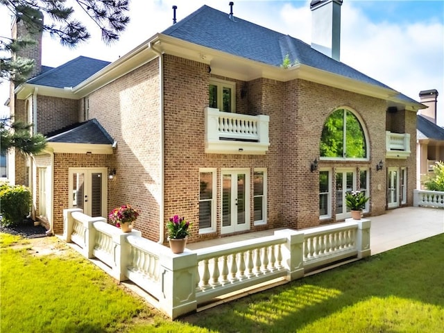 8370 Royal Melbourne Way, Duluth, GA 30097 - rear view of house with french doors, a chimney, brick siding, and a balcony