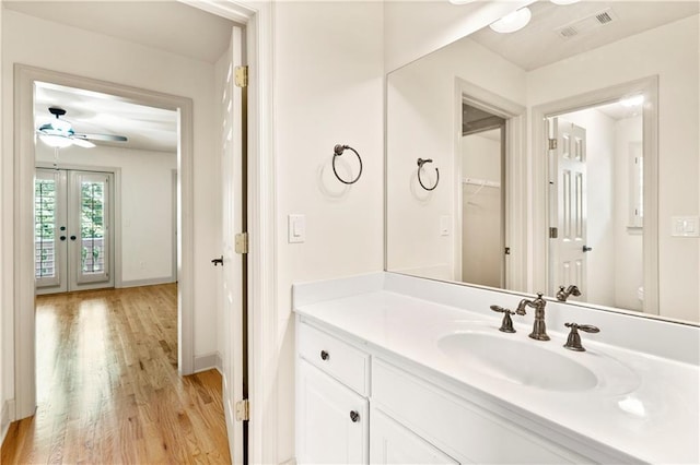 8370 Royal Melbourne Way, Duluth, GA 30097 - bathroom with wood finished floors, ceiling fan, vanity, and french doors