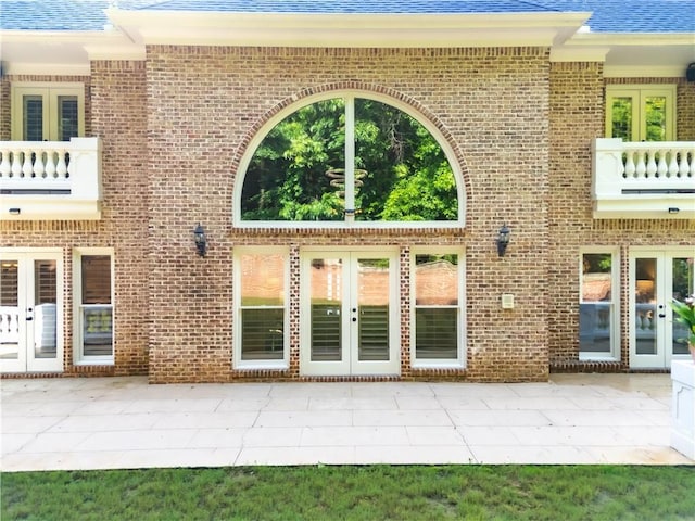 8370 Royal Melbourne Way, Duluth, GA 30097 - view of exterior entry featuring french doors, a patio, and brick siding