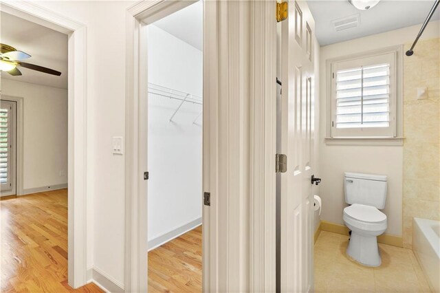 8370 Royal Melbourne Way, Duluth, GA 30097 - bathroom featuring ceiling fan, wood finished floors, and a walk in closet